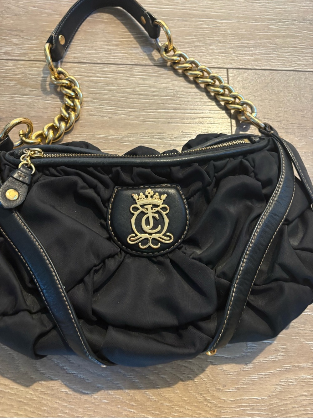 Black Quilted Shoulder Bag with Gold Chain and Crest Emblem
